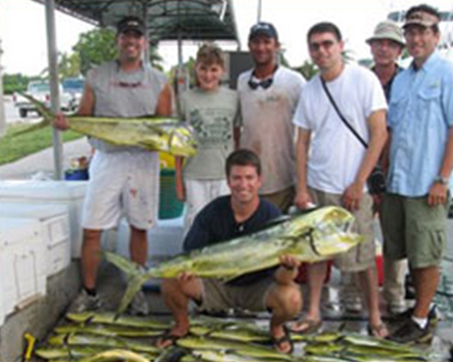 group of people, two holding big fish
